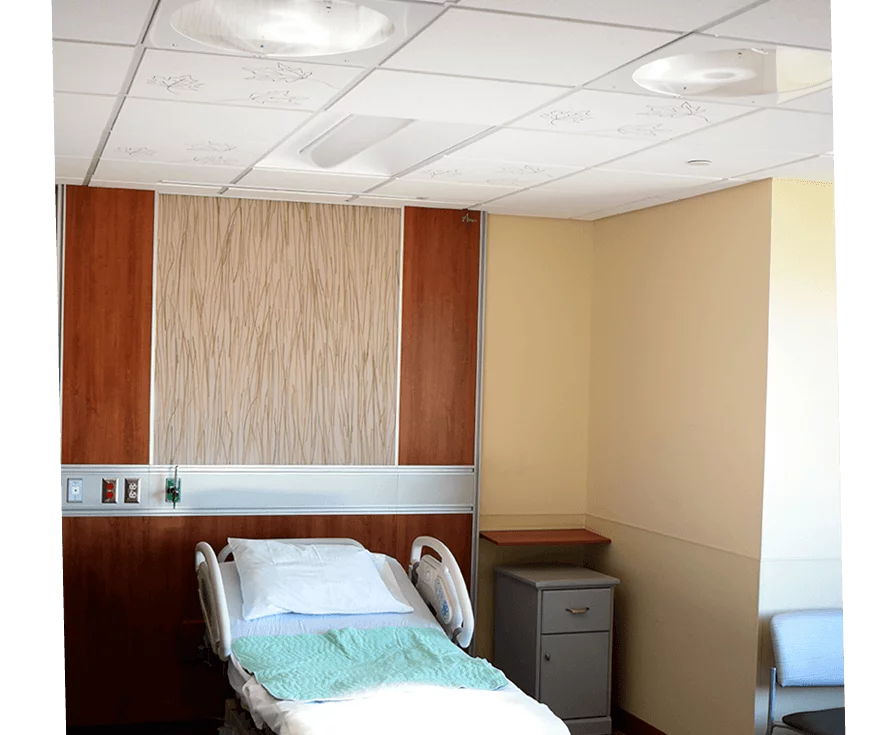 Patient bed in a labor and delivery room with Skytron Lucina 4 ceiling lights
