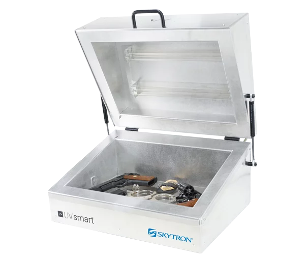 Skytron UV Smart counter top UVC disinfection device holding common correctional facility items